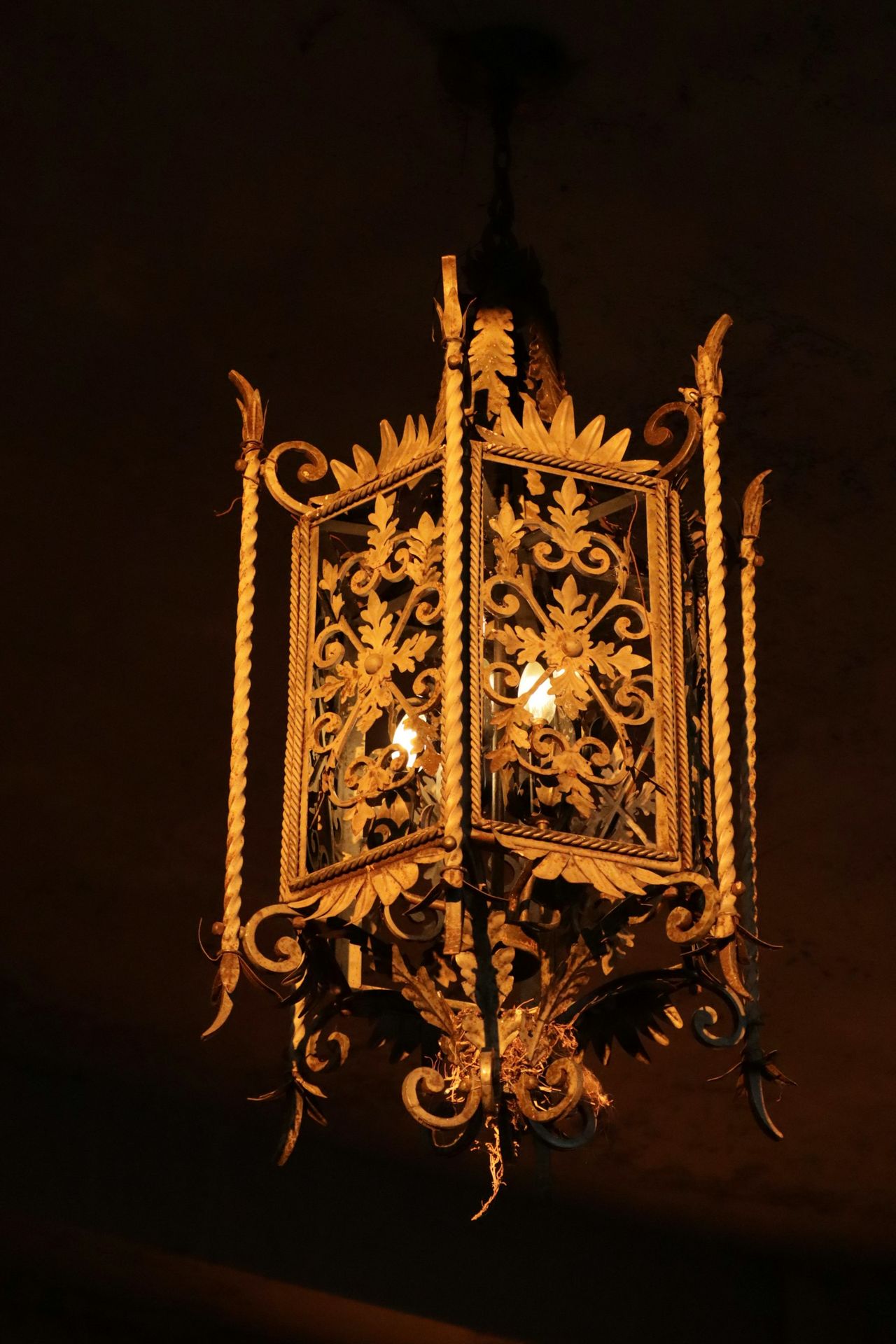 a chandelier hanging from the ceiling in a dark room